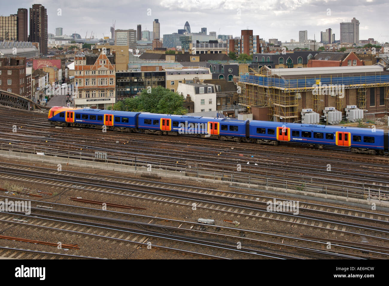 View of a suburban train and rail tracks outside London's Waterloo train station. Stock Photo
