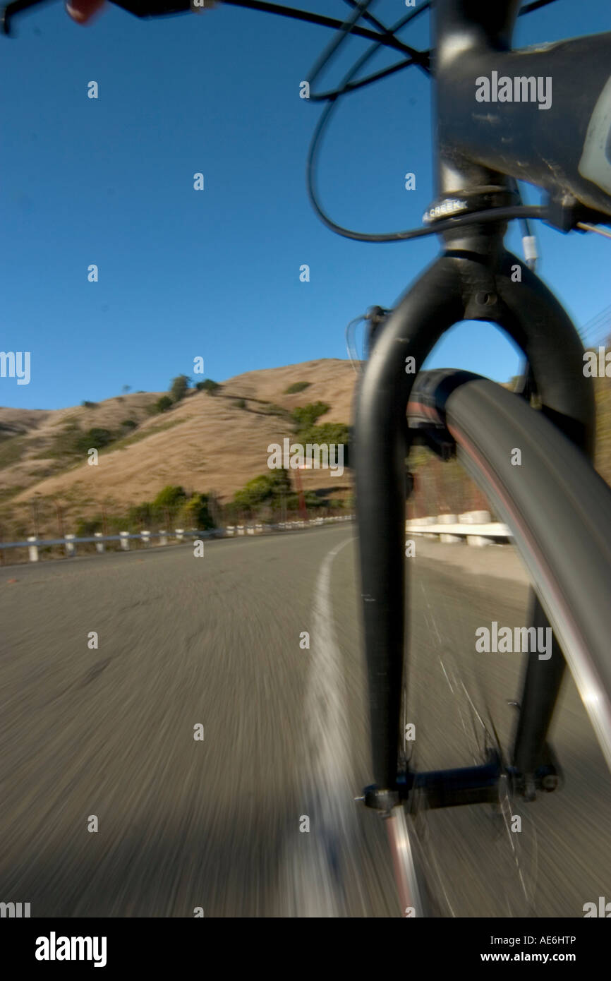 Low POV of bike wheel, road, and hill Stock Photo Alamy