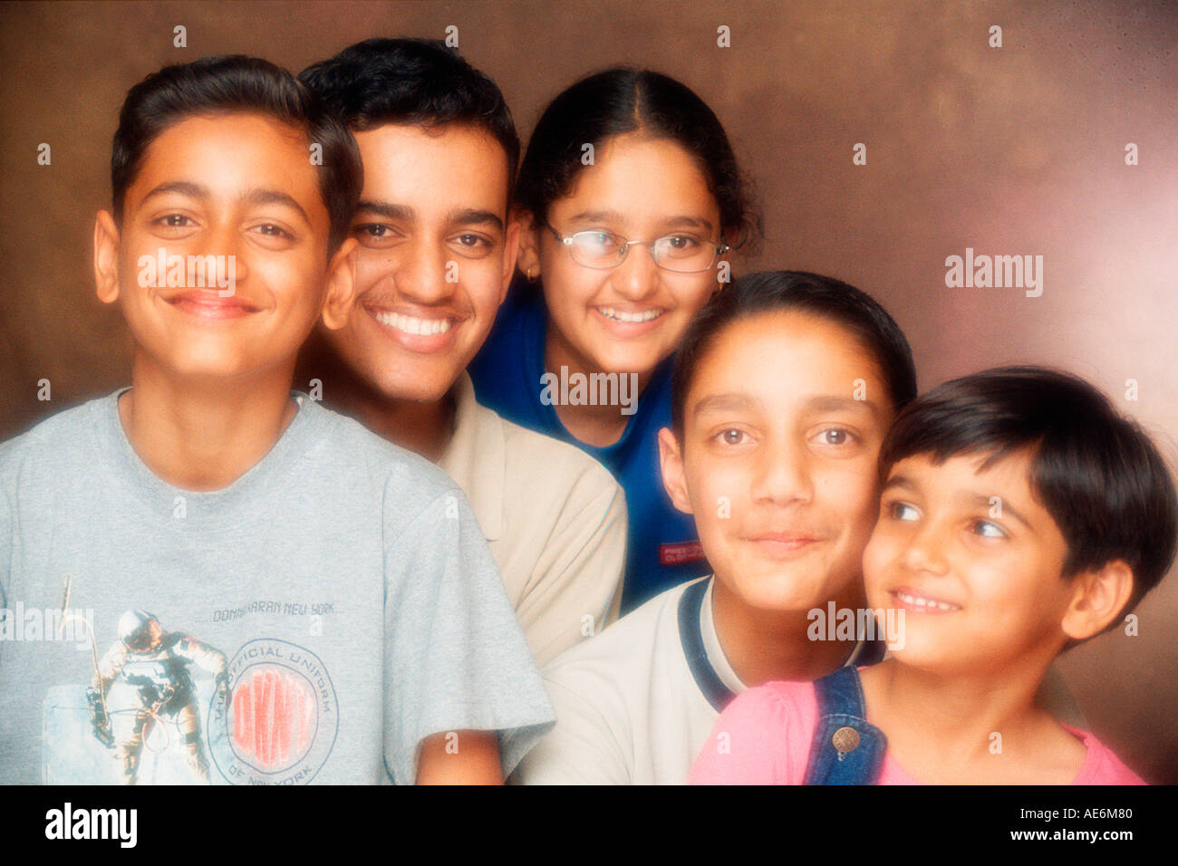 South Asian Indian family with four brothers and one sister looking at the camera with smile Model Release numbers 518 and 519 Stock Photo