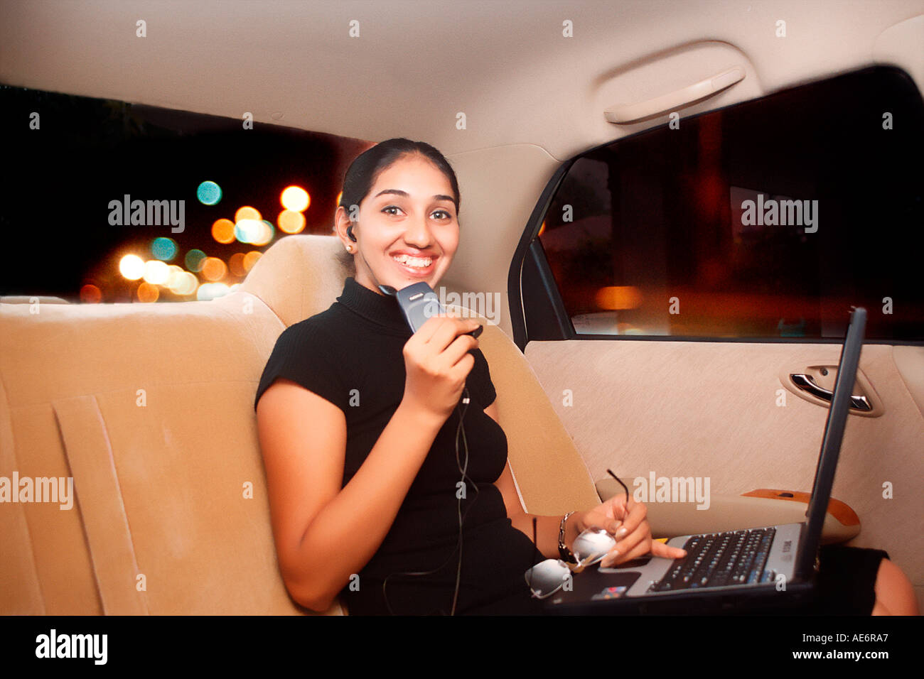 RHS70945 South Asian Indian young executive lady in a car looking to the camera with smile Model Release 522 Stock Photo