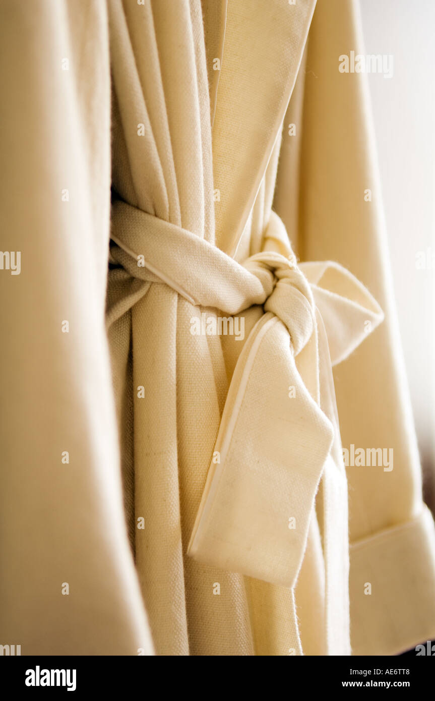 detail of white dressing gown with waist tie . Stock Photo