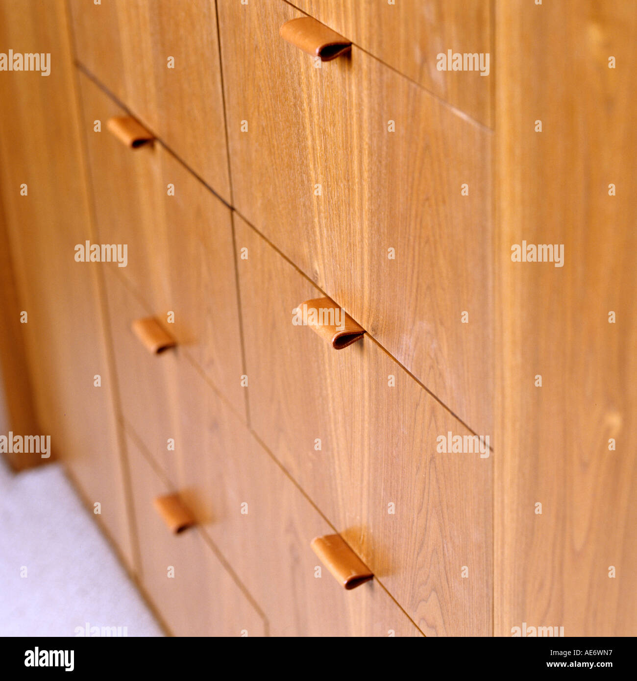 Detail of wooden storage unit and leather drawer pulls Stock Photo