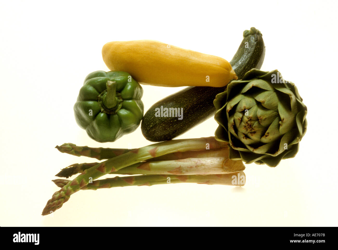 Vegetables on light table Summer squash zucchini squash asparagus artichoke and green pepper Stock Photo