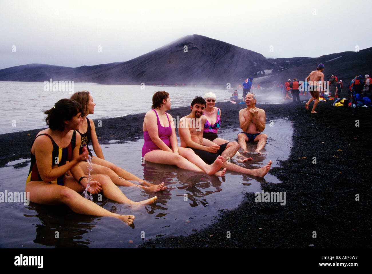 Tourists enjoying hot springs on beach of Deception Island in Antarctic Stock Photo