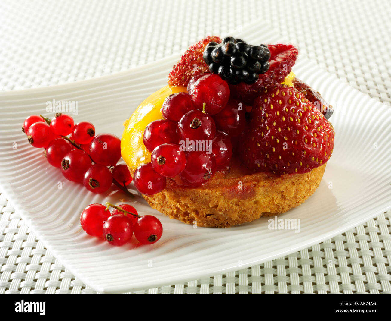 Individual fruit tart with fruits of the forest and creme patisserie Stock Photo