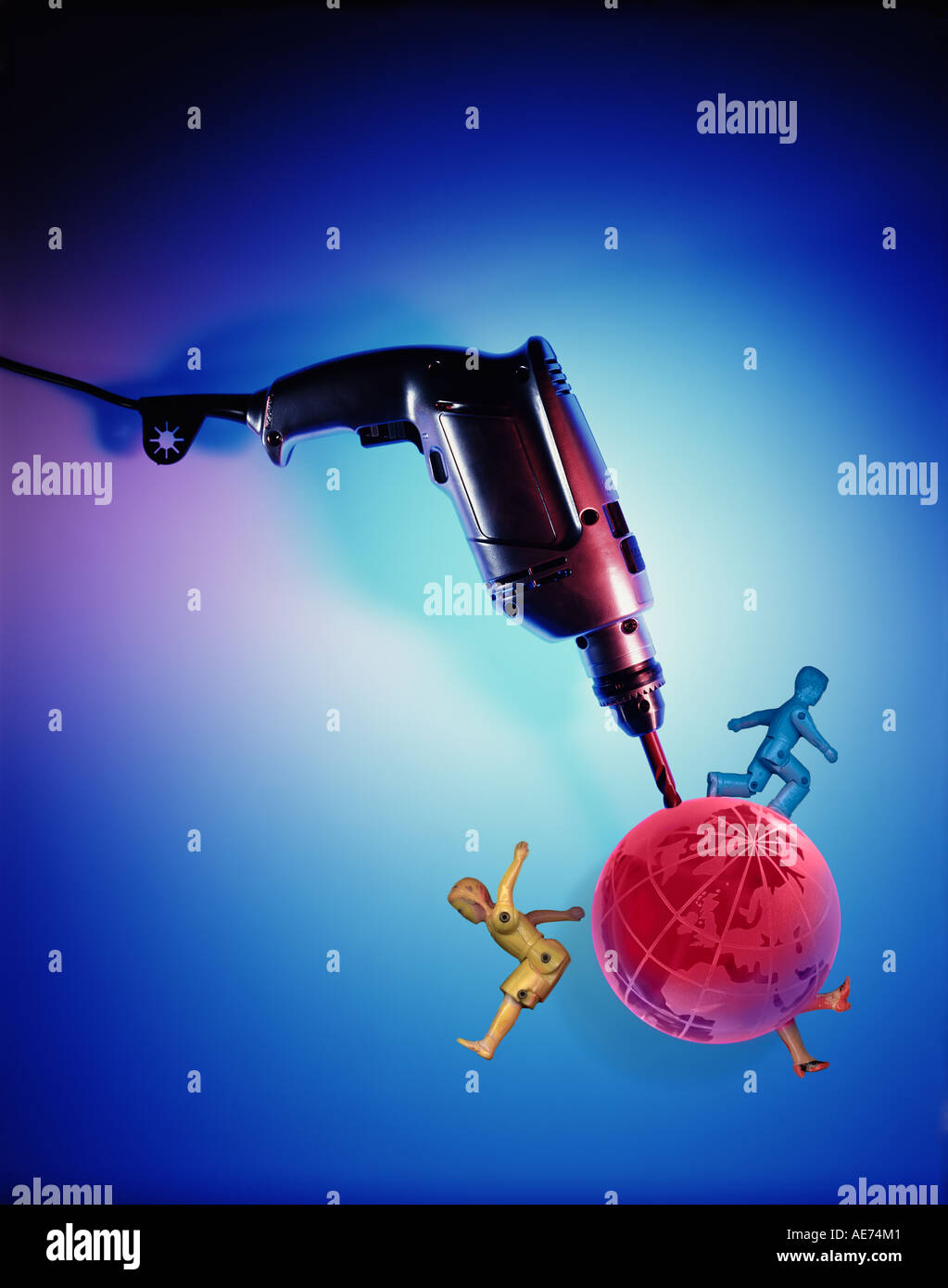 Mining the Earth. An electric power drill drilling into a transparent pink globe of the earth Stock Photo