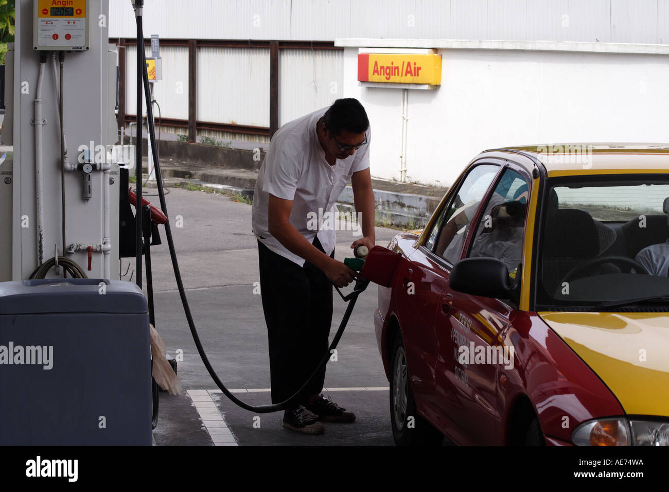Gas Station, Driver Filling a Taxi With Fuel in Kuching, Sarawak