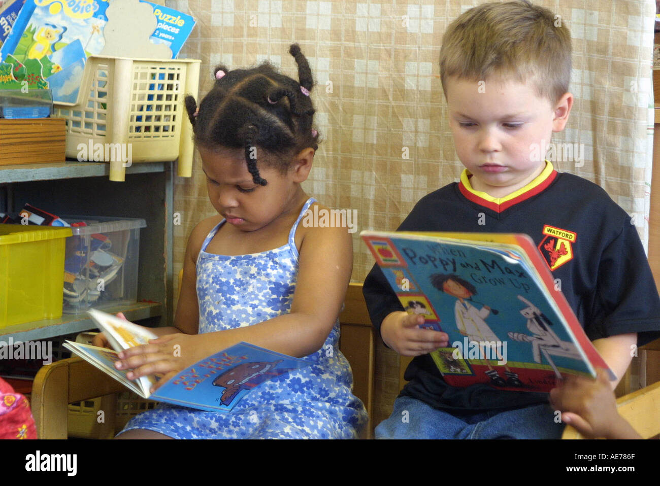Boy and girl reading books in Nursery School Stock Photo - Alamy