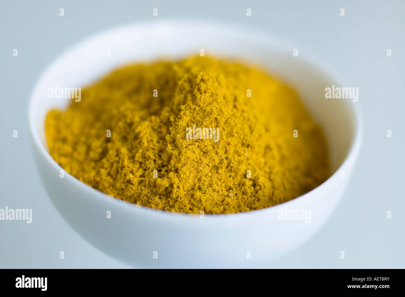 curry powder traditional indian spice in white bowl Stock Photo