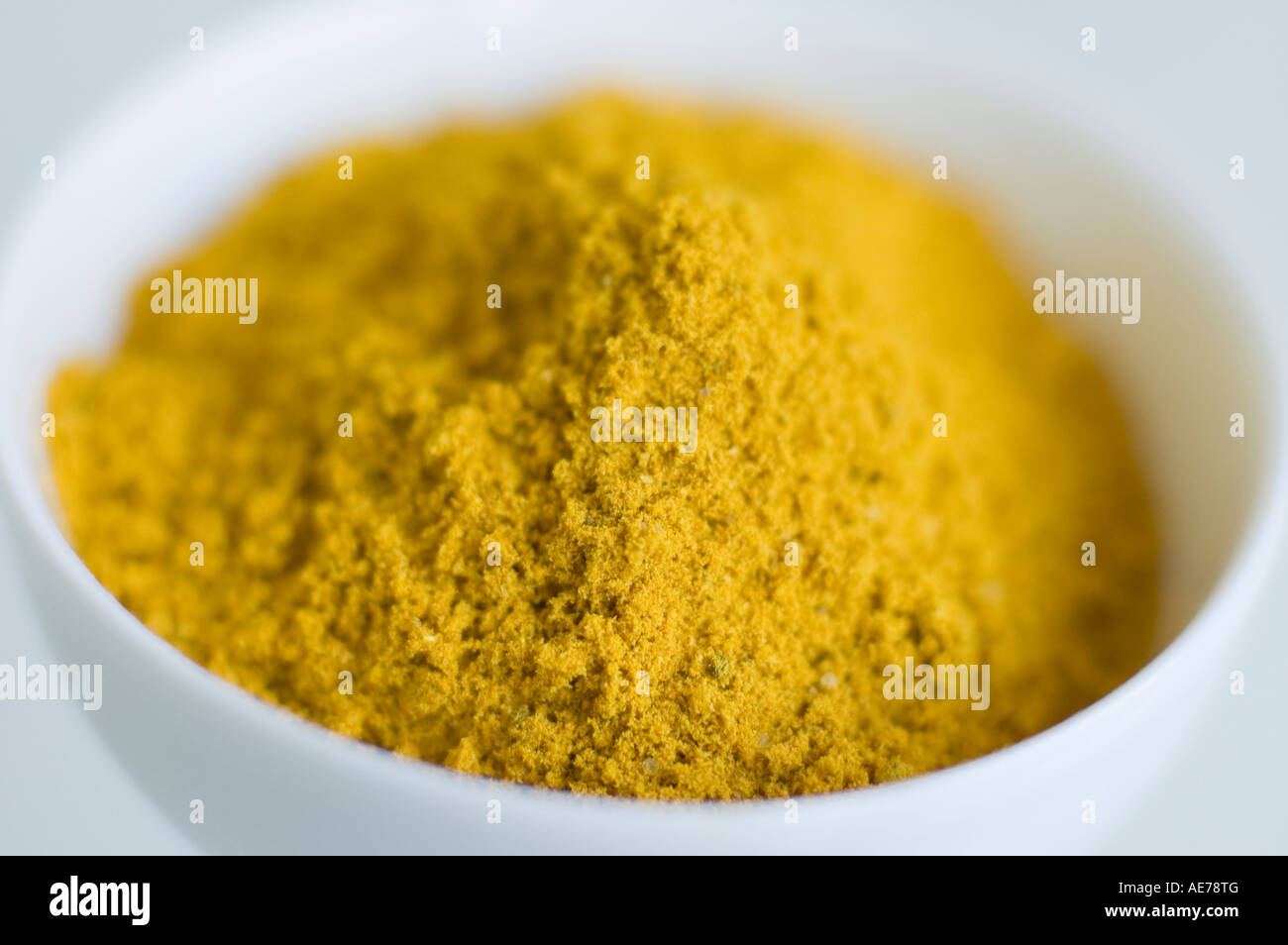 curry powder traditional indian spice in white bowl Stock Photo