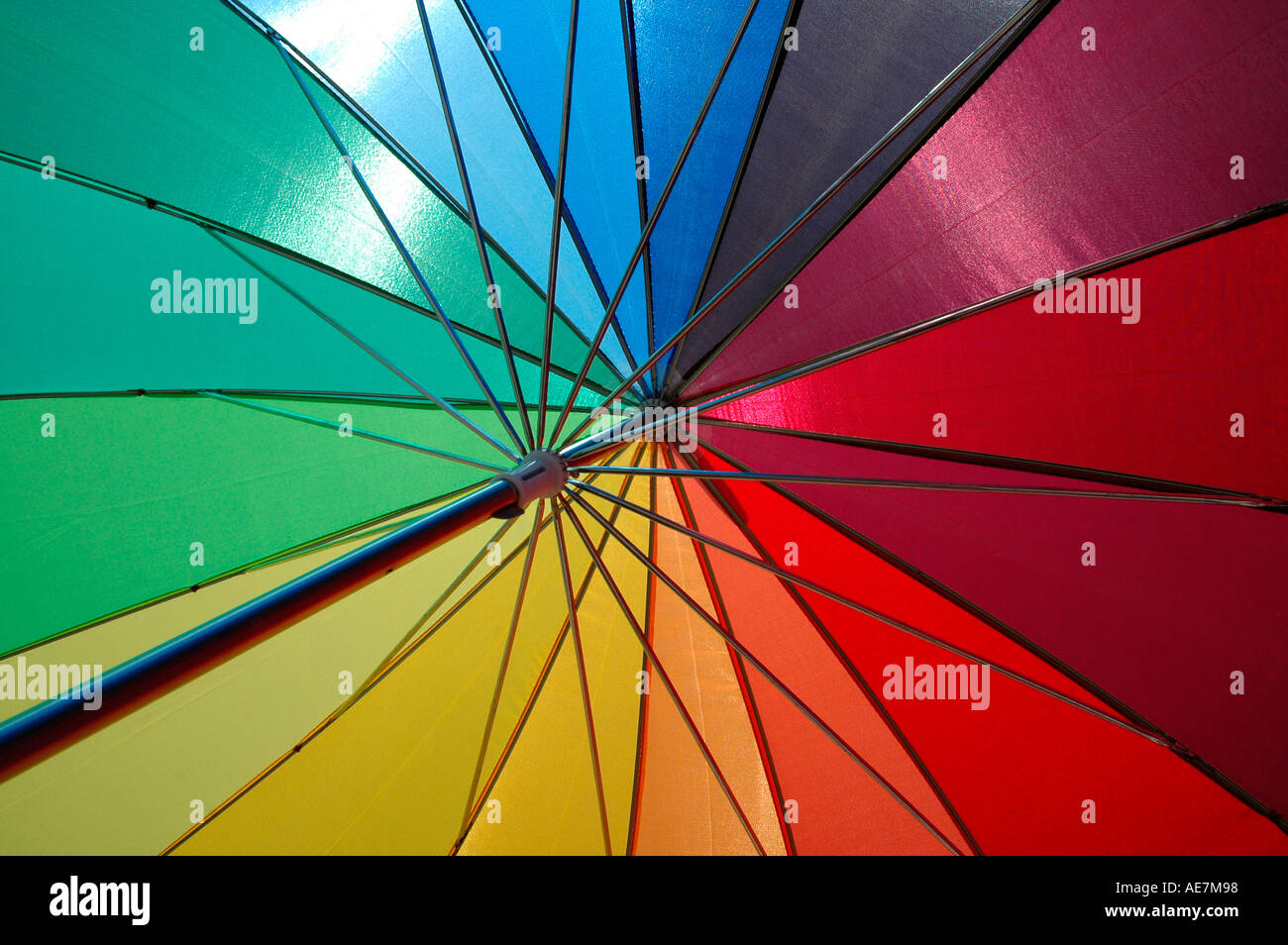 Colourful umbrella with sun shining through it Stock Photo