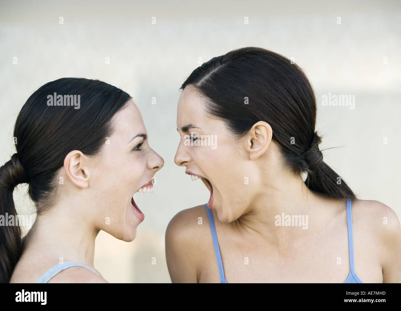 Two young women screaming at each other Stock Photo