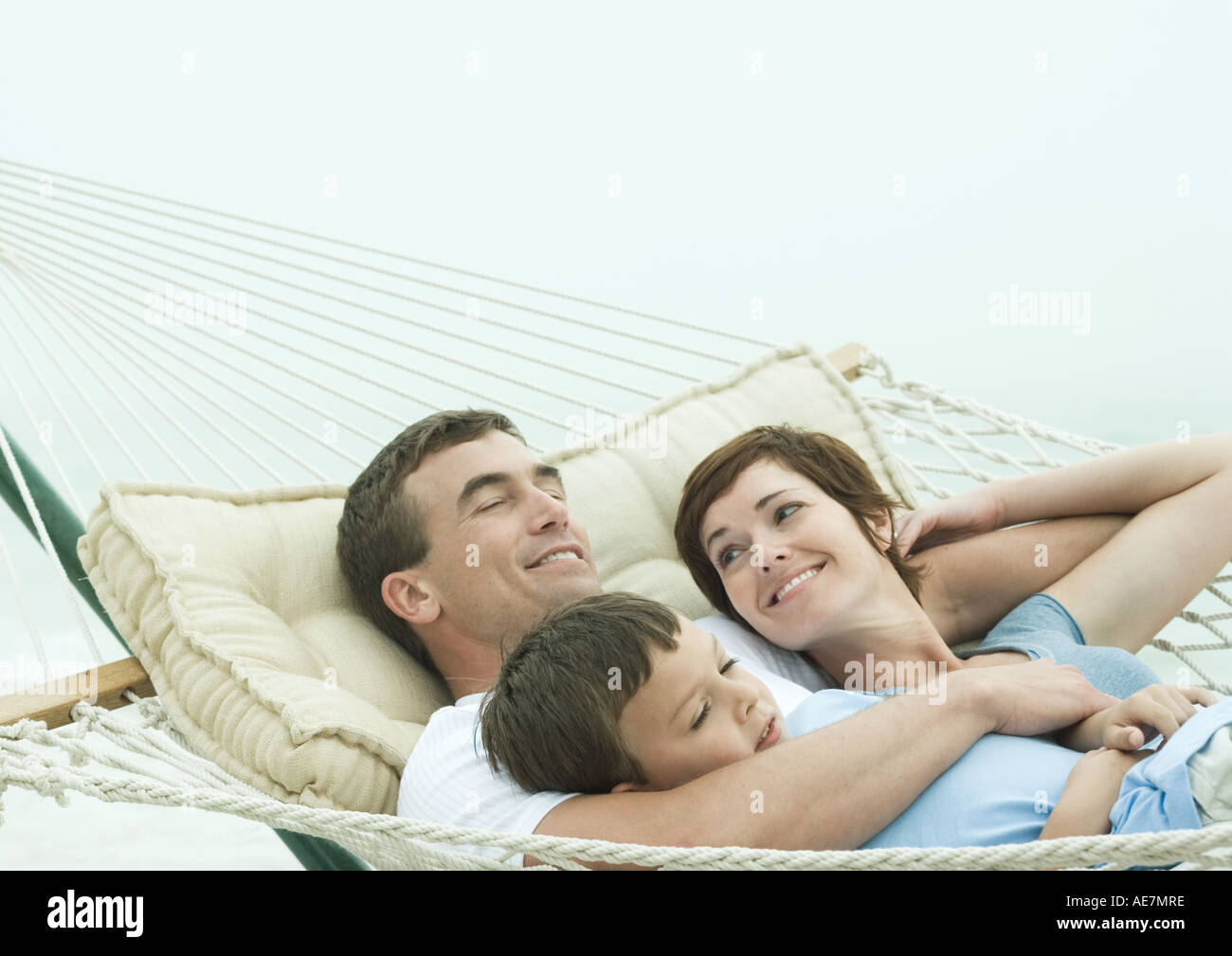 Family relaxing in hammock Stock Photo