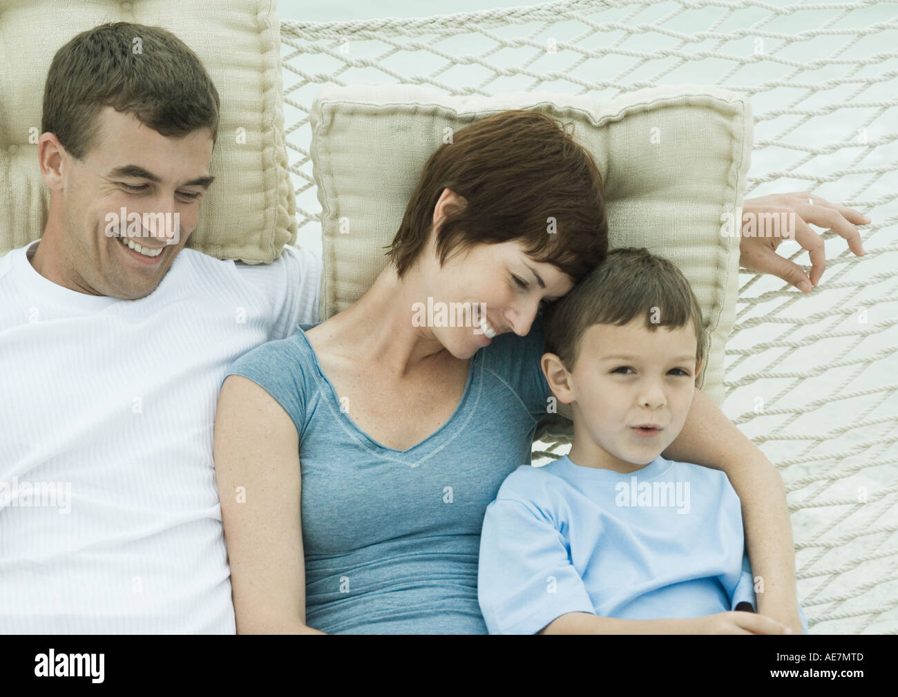 Family relaxing in hammock Stock Photo