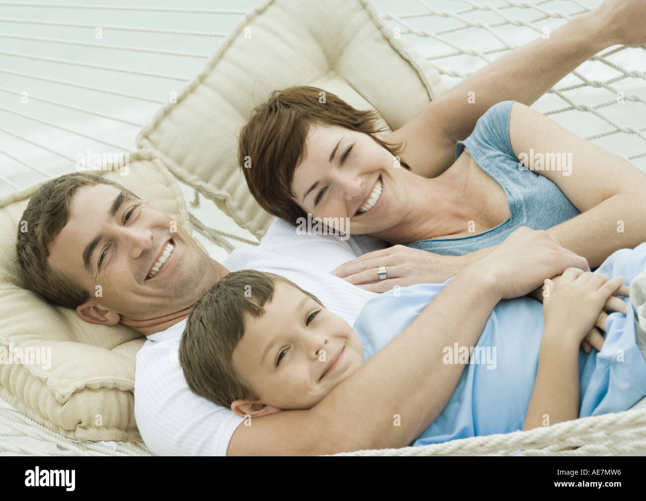 Family relaxing in hammock Stock Photo