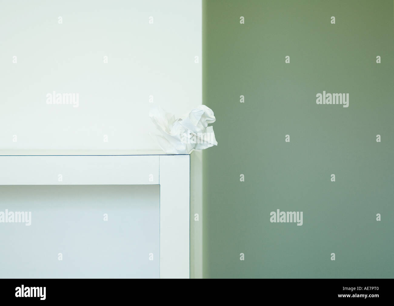 Crumpled piece of paper on edge of table Stock Photo