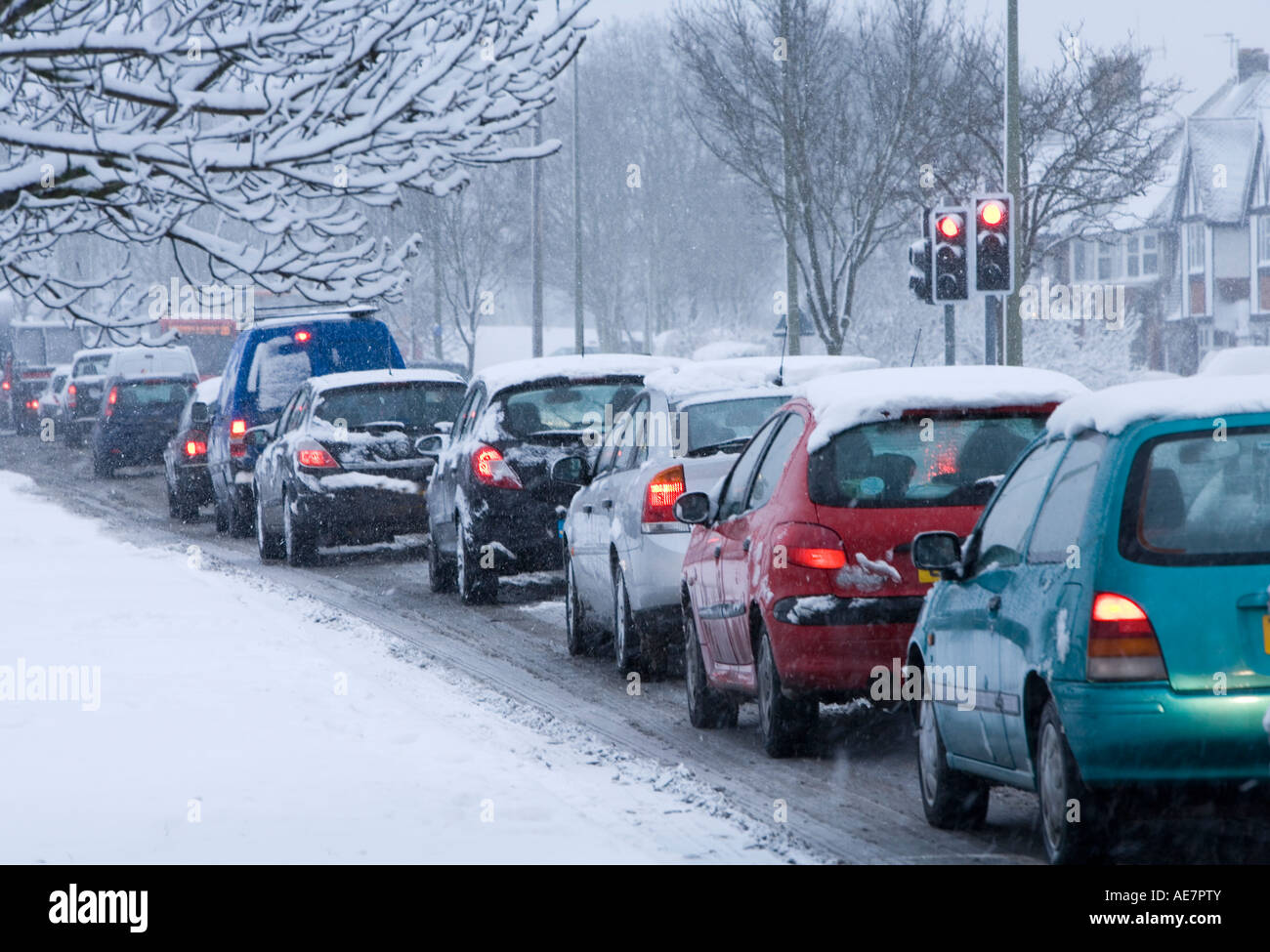 commuter cars queuing in rushhour traffic in snow , england Stock Photo
