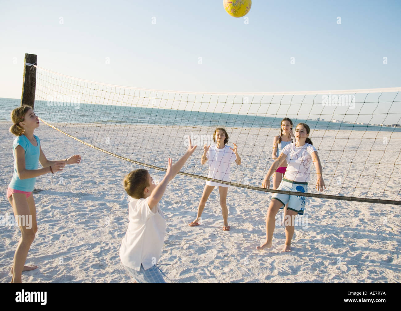 Group of kids playing beach volleyball Stock Photo - Alamy