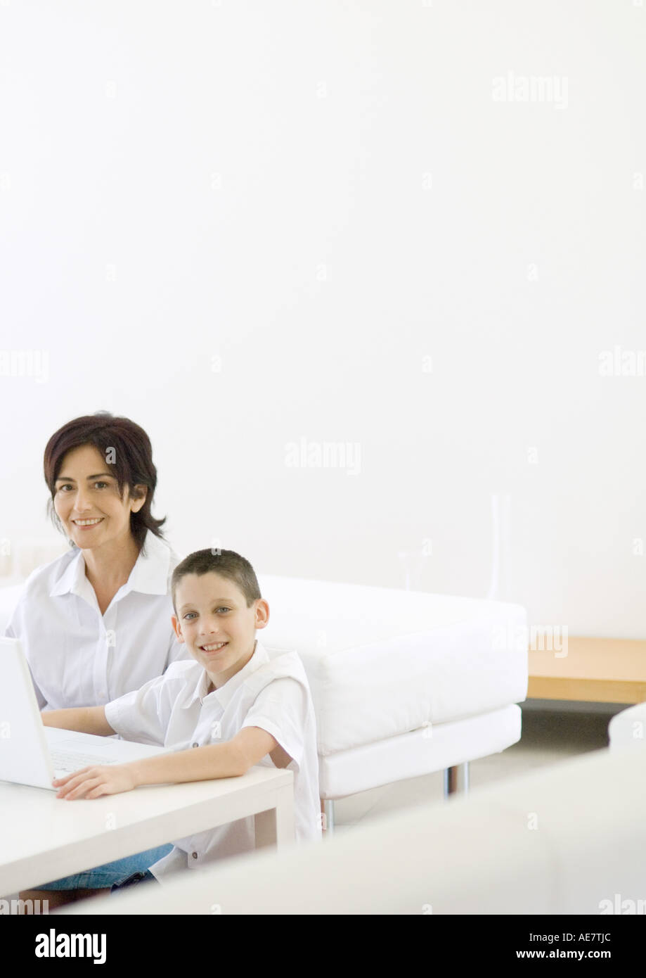 Boy and mature woman using laptop Stock Photo