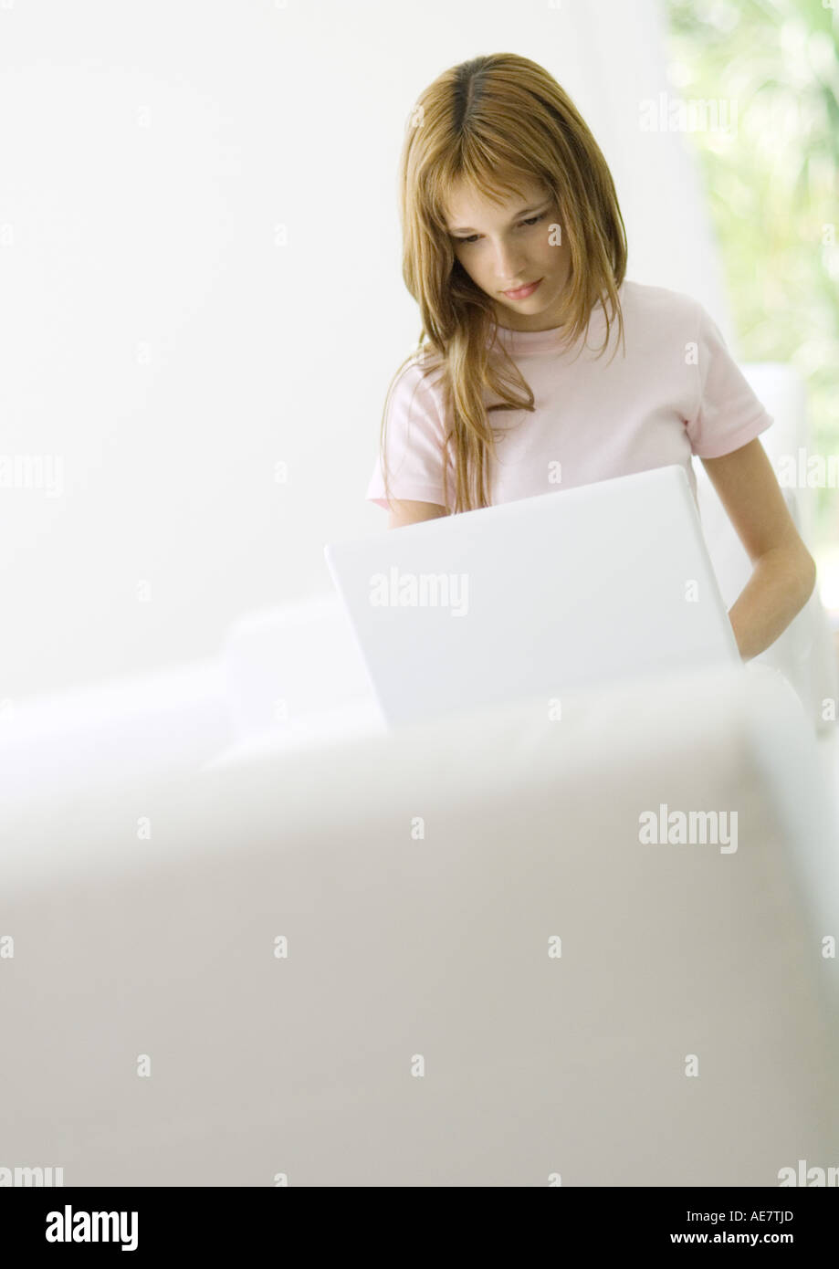 Preteen girl using laptop Stock Photo - Alamy
