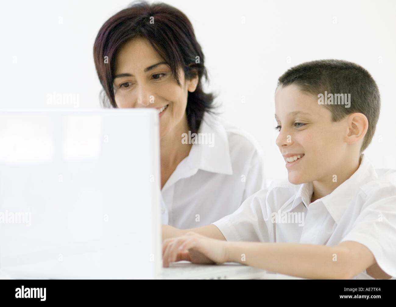 Boy and grandmother using laptop Stock Photo