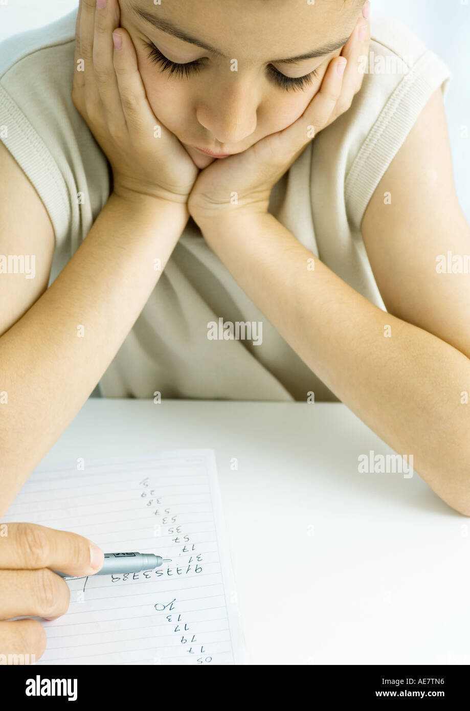 Boy doing homework with father's help, cropped Stock Photo
