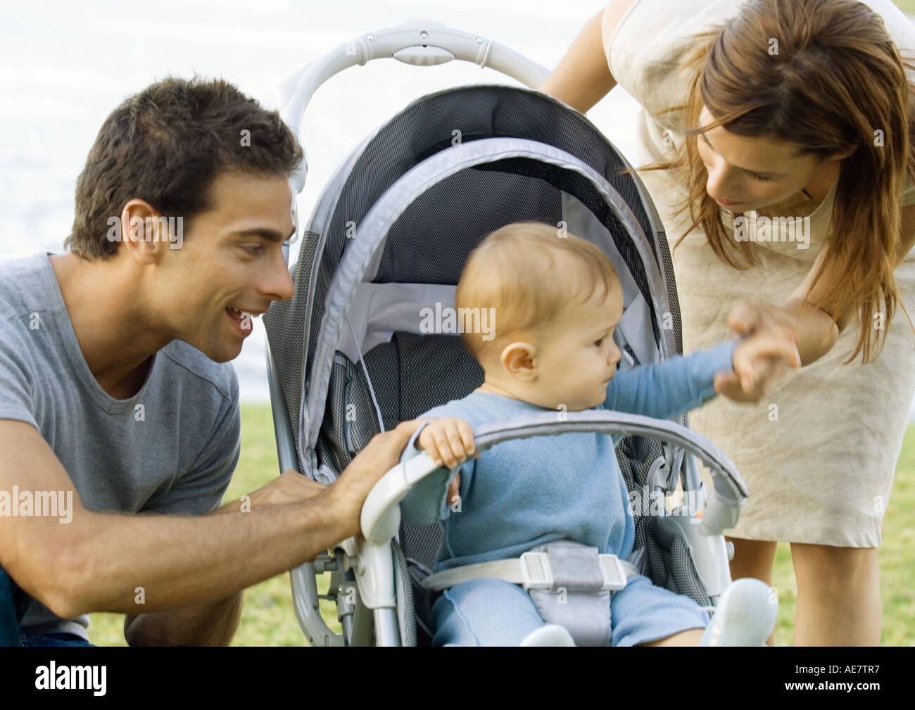 Young couple with baby in stroller Stock Photo