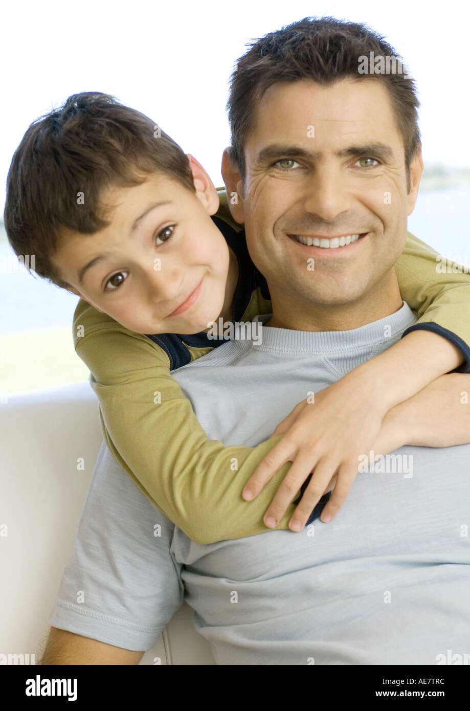 Boy hugging father from behind, portrait Stock Photo