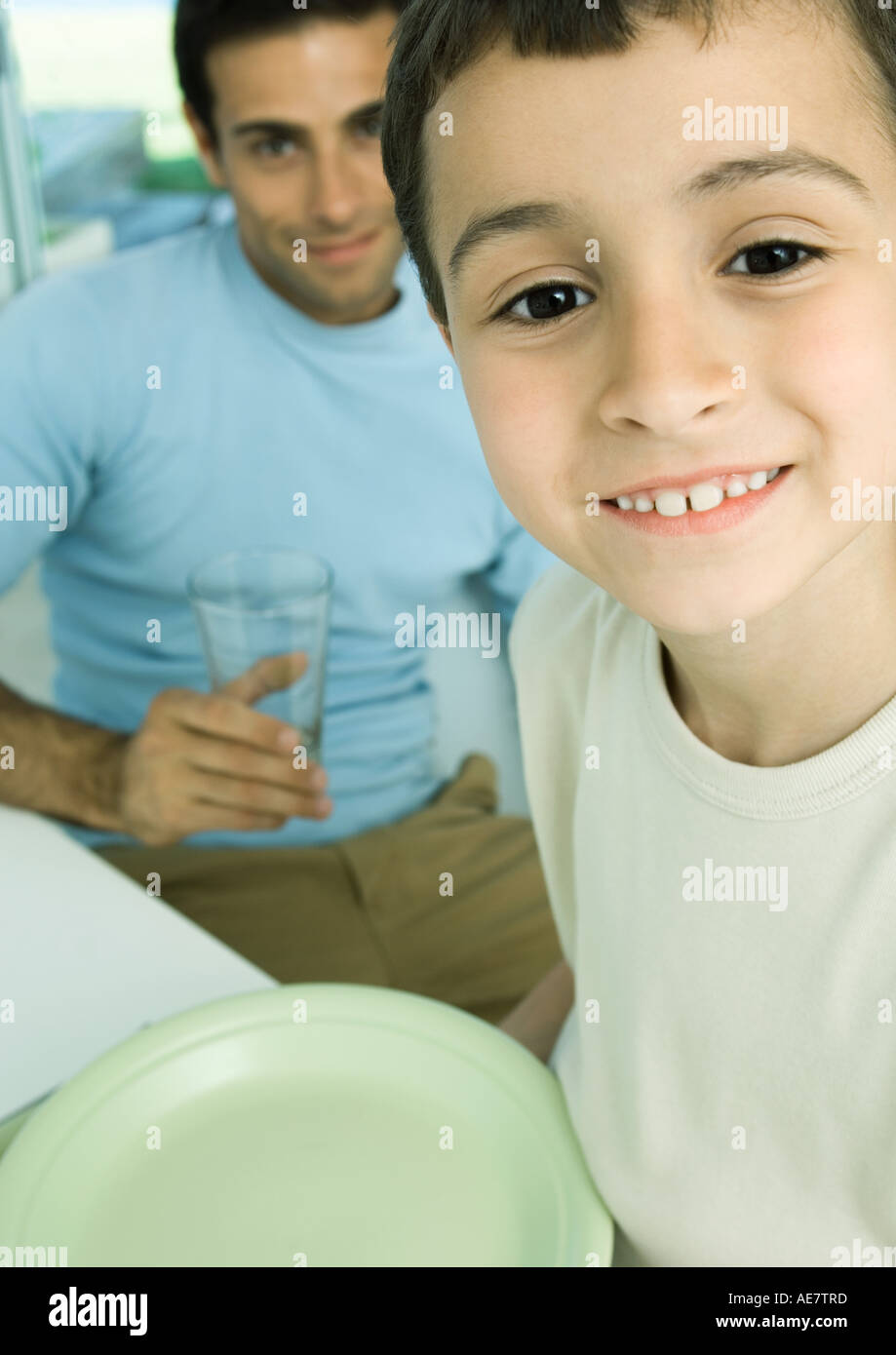 Boy and father with dishes Stock Photo