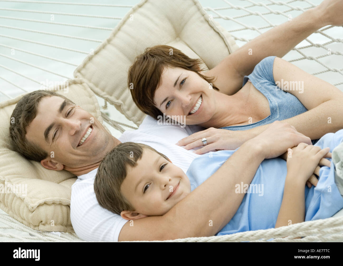 Family lying in hammock, smiling Stock Photo
