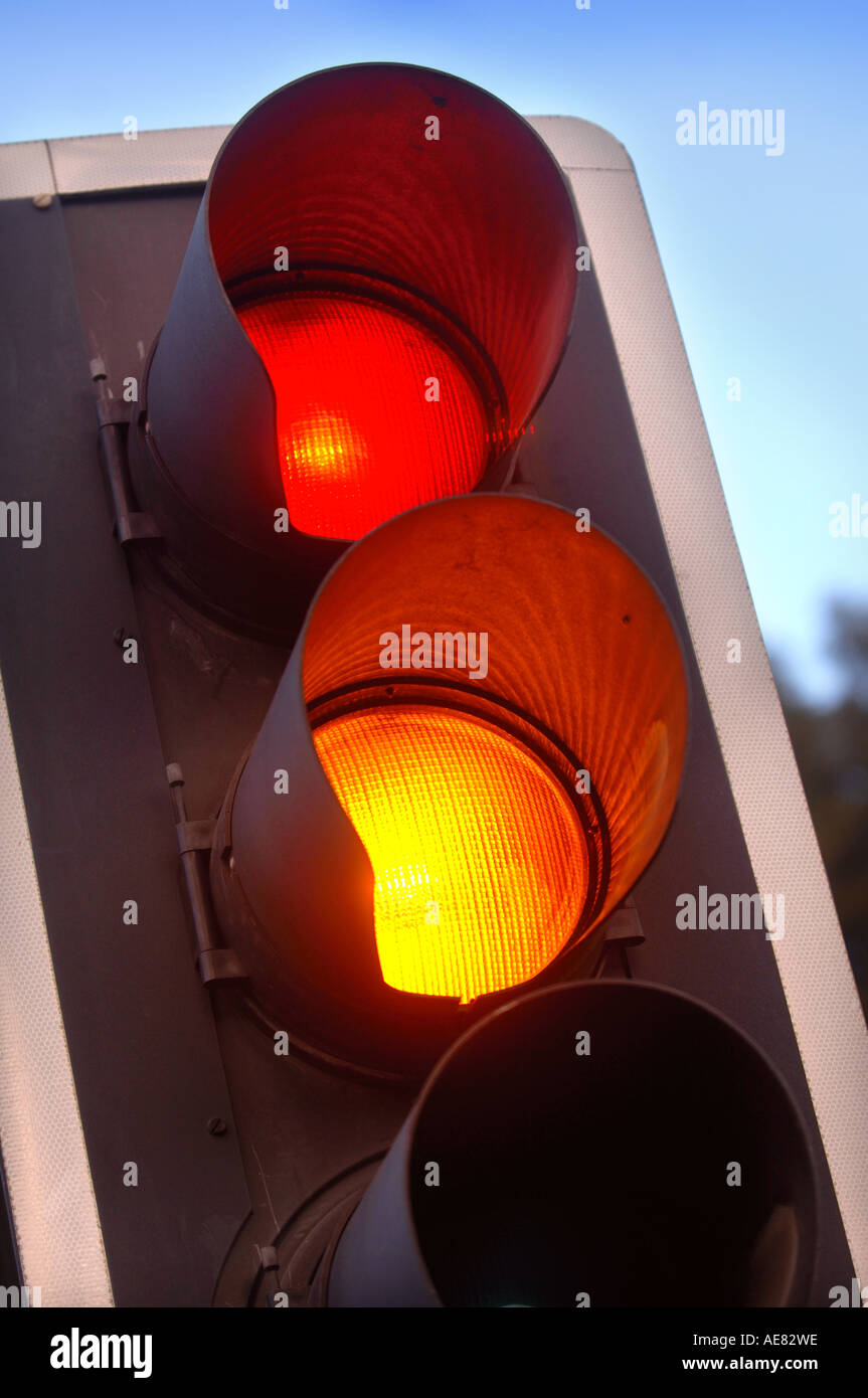 TRAFFIC LIGHTS SHOWING AMBER AND RED AT A CROSSROADS IN THE UK Stock