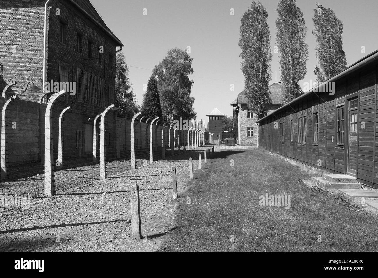 Perimeter fence and prison block at Auschwitz, Poland. Stock Photo