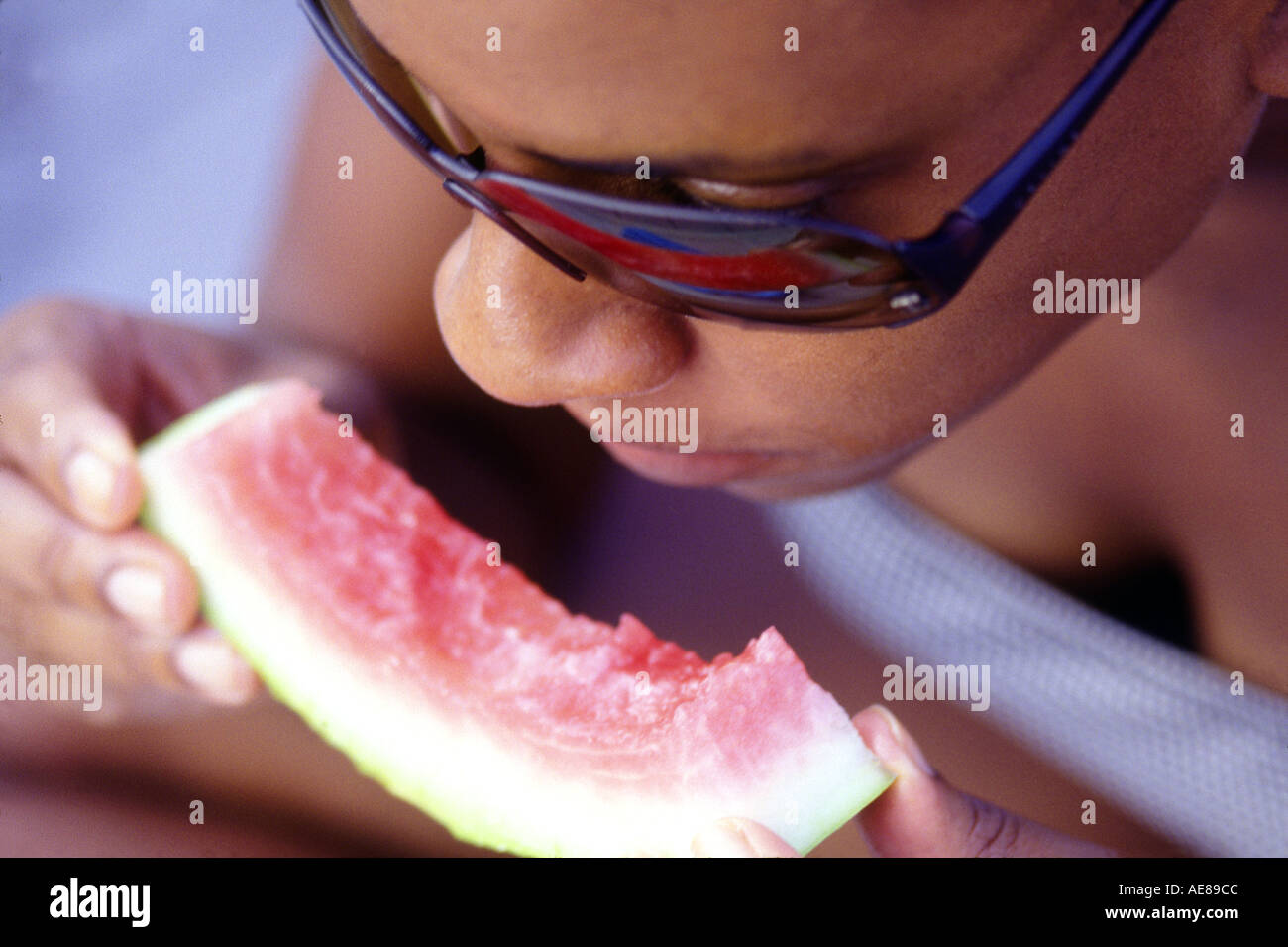 African American Woman eating watermelon Stock Photo