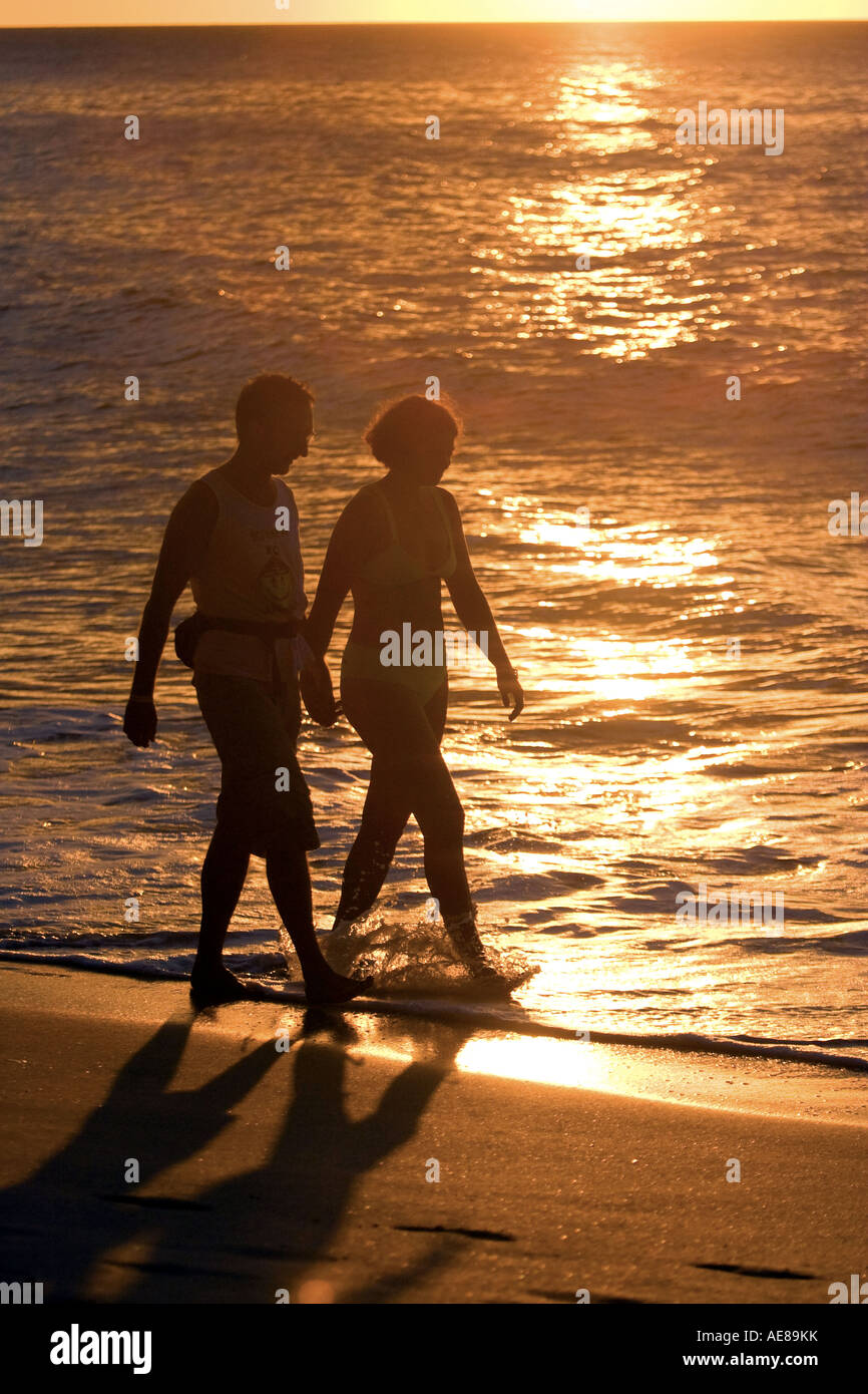couple walking on the beach Stock Photo - Alamy
