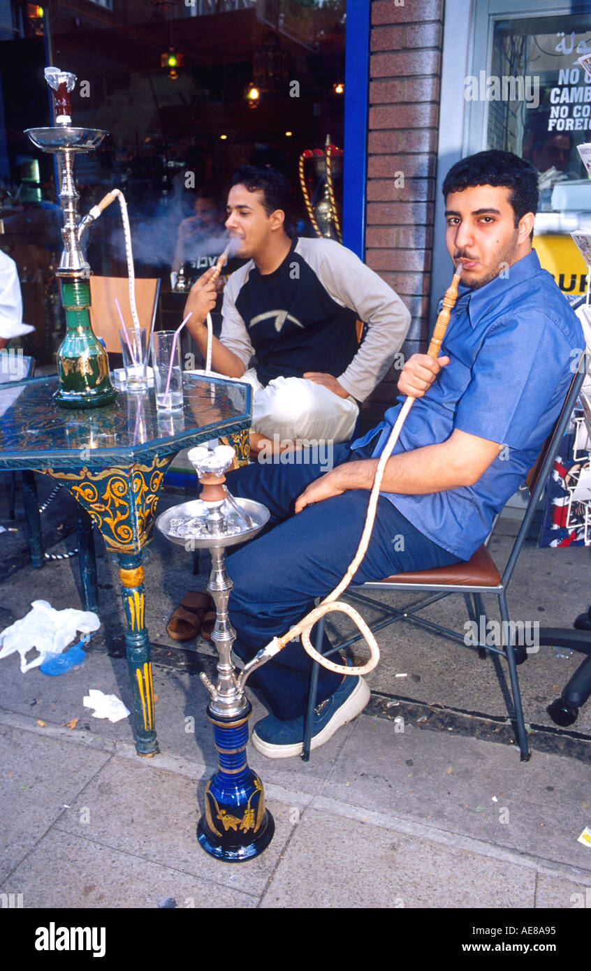 Turkish men smoking tobacco with a water pipe at a sidewalk cafe in London  England Stock Photo - Alamy