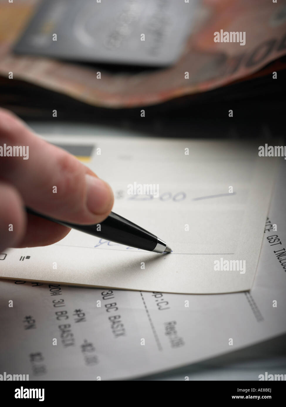 person signing check for cash and paying bill stock photo signing a check