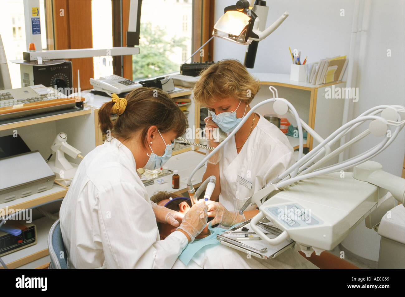 Female dentist with assistant talking on phone in Helsinki Finland Stock Photo Alamy