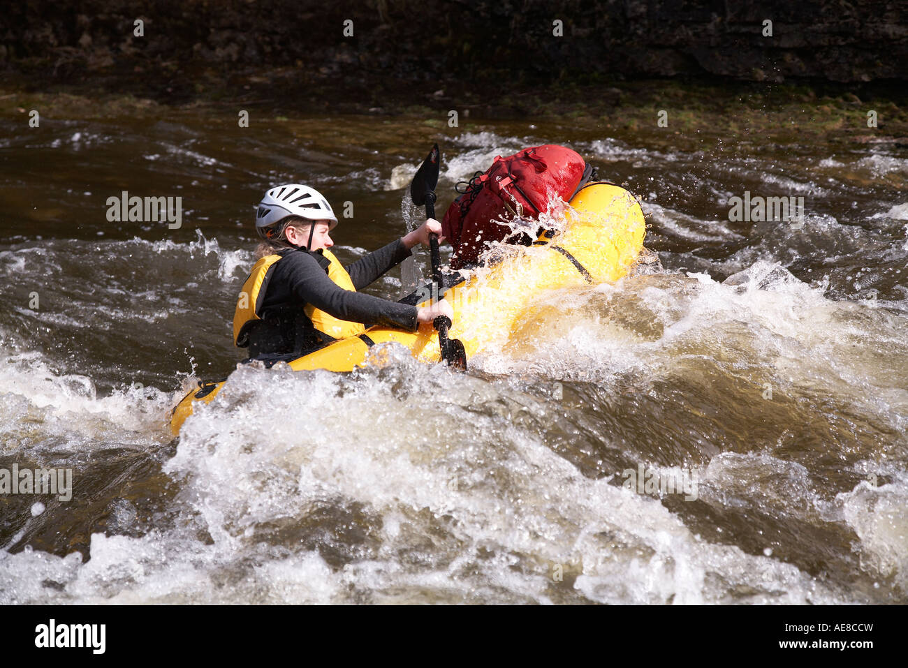 Woman in packraft negotiates a rapid on Grand River Ontario Canada Stock Photo