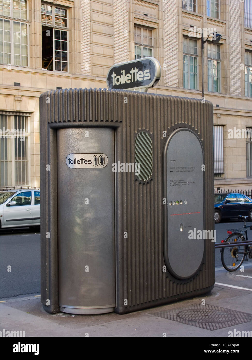Public coin operated pay toilet on sidewalk Paris France Stock Photo