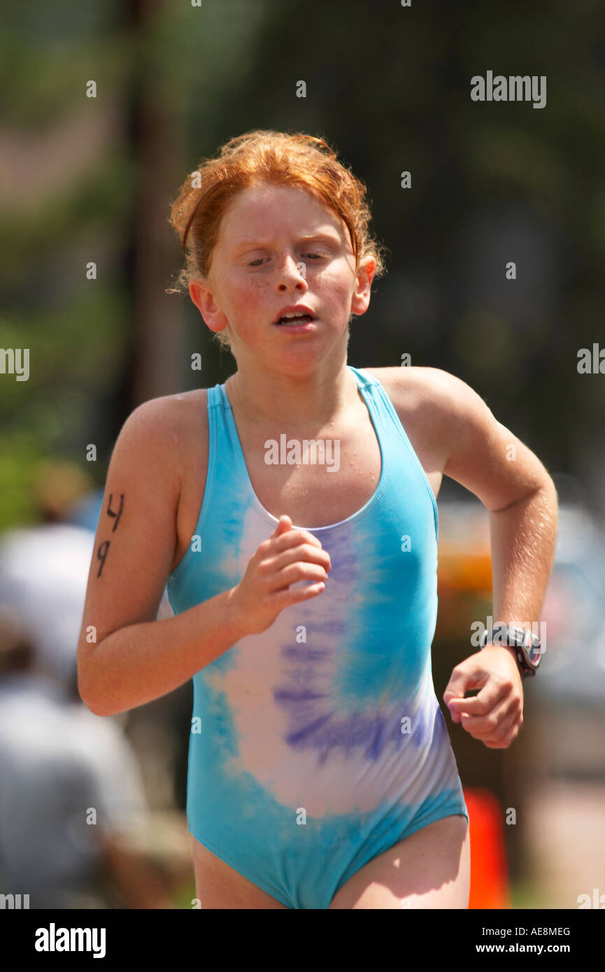 Young girl running during a youth triathlon event Stock Photo Alamy