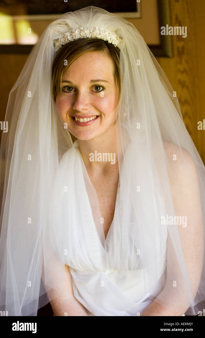 Portrait of a young bride taken on her wedding day smiling Stock Photo ...