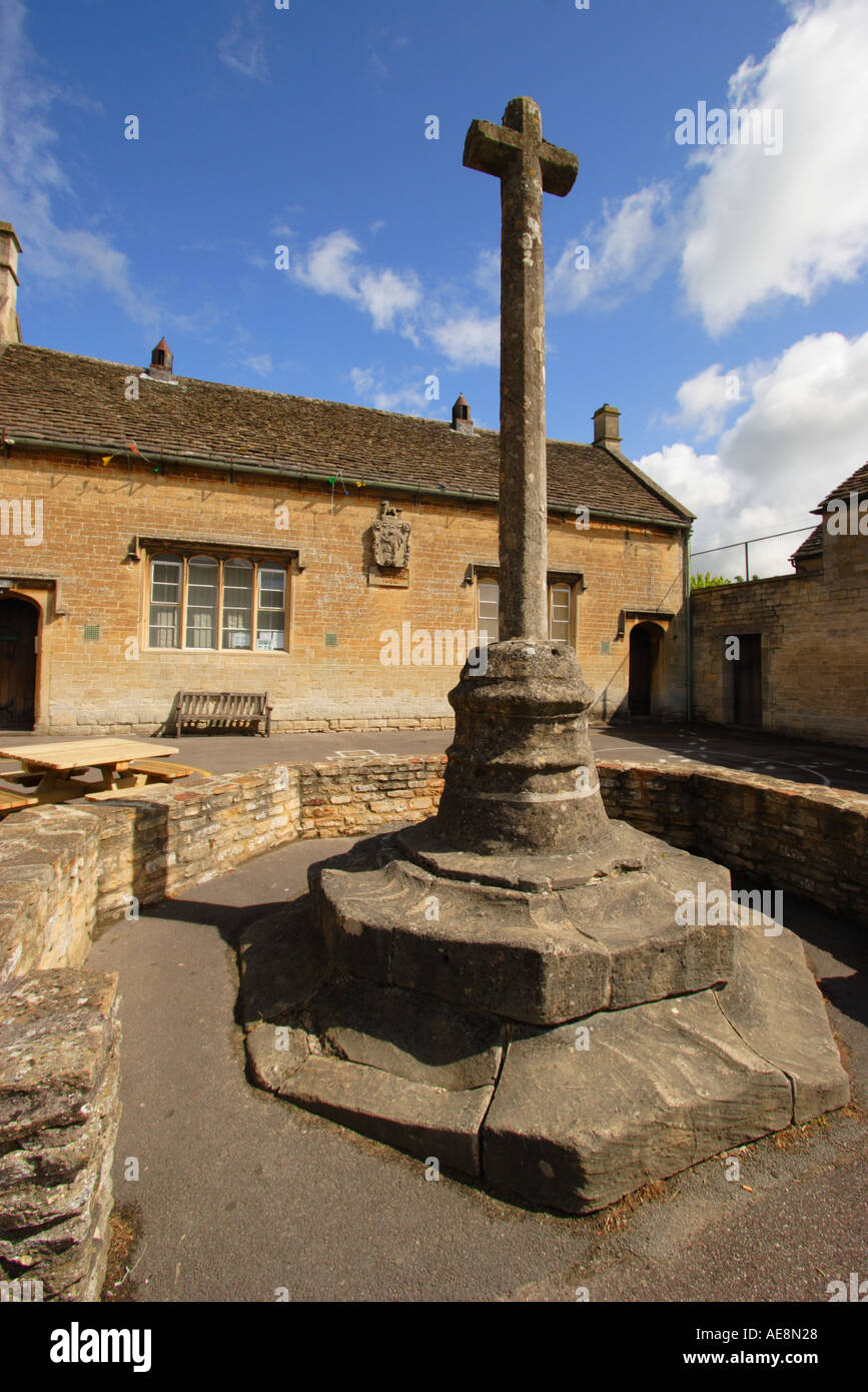 School playground in picture postcard village of Lacock and ancient stepped cross Stock Photo