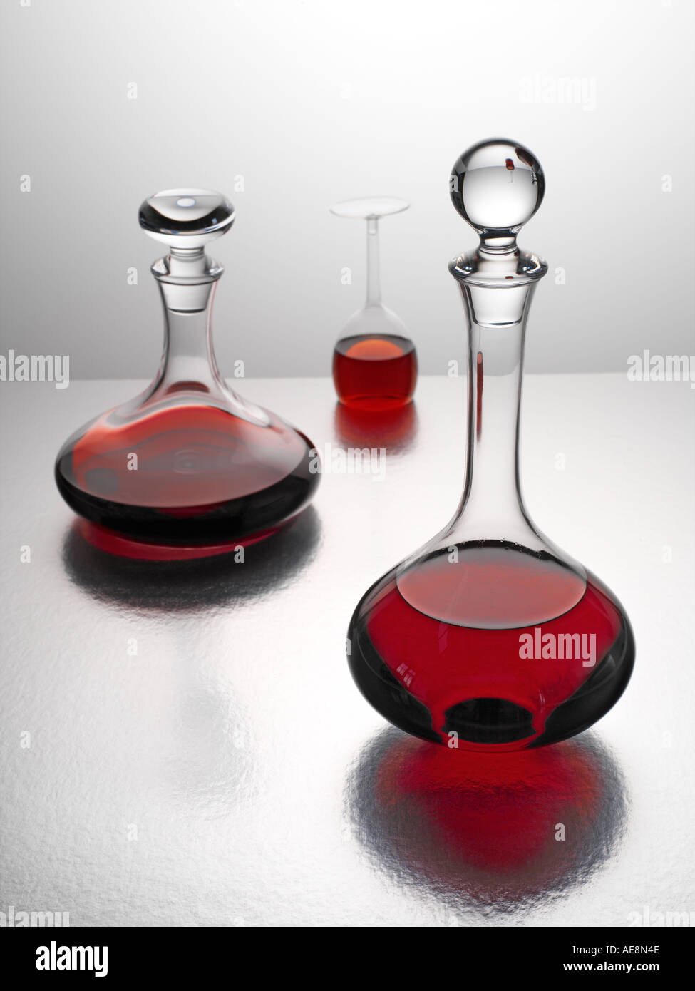 Two decanters of red wine and upturned glass Stock Photo Alamy