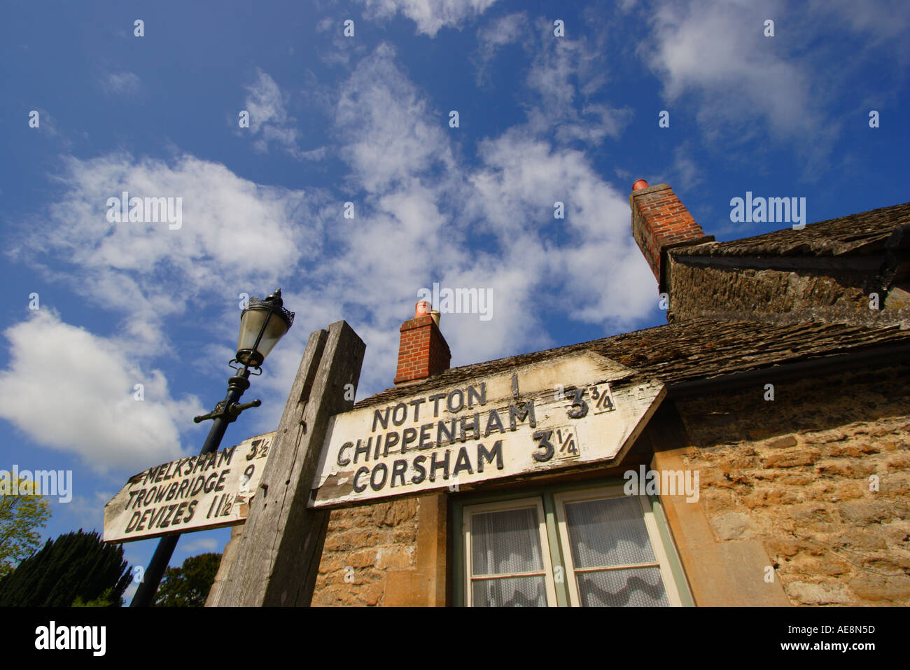 Old fashioned road signs in the village of Lacock Wiltshire Stock Photo