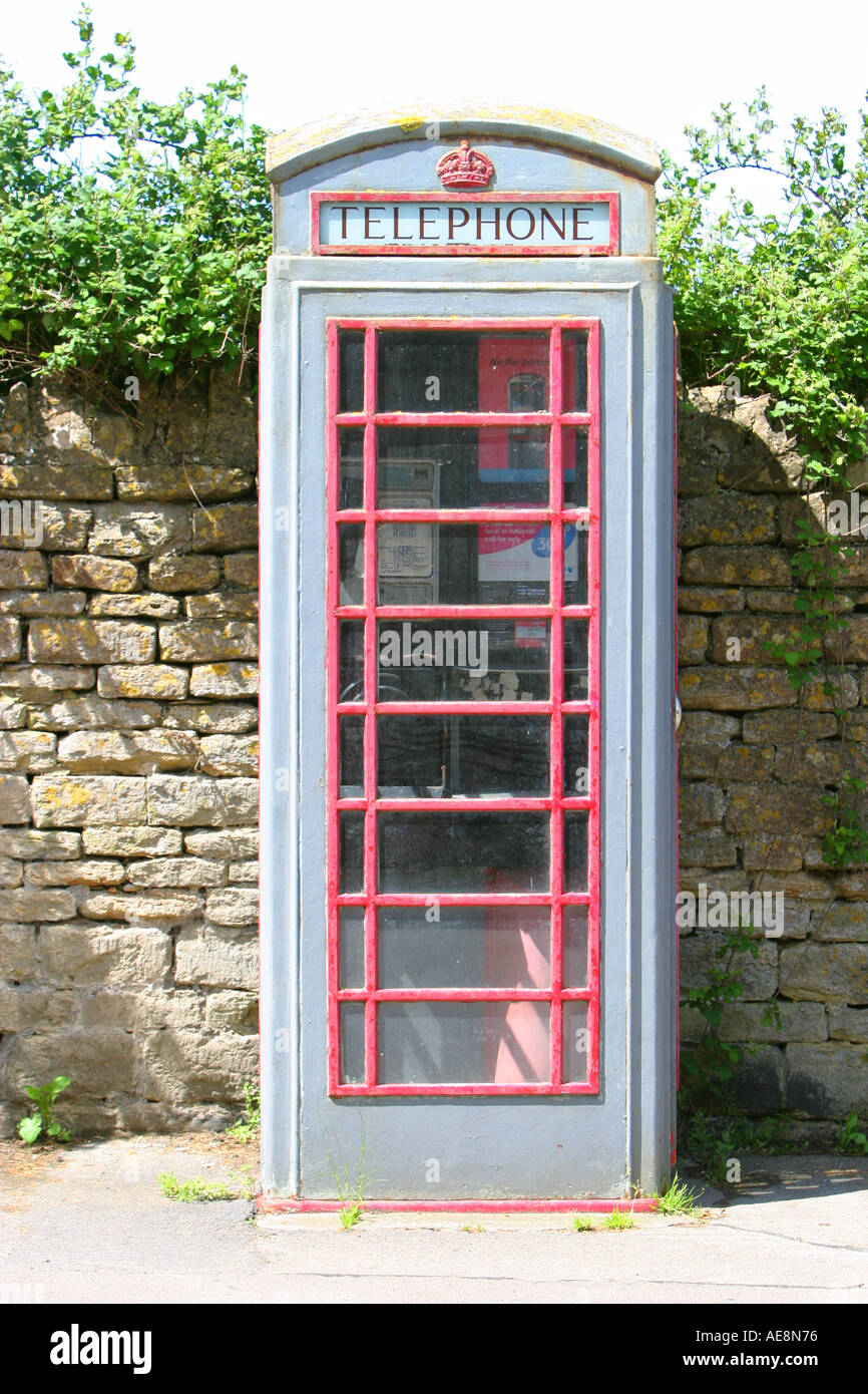 Traditional red telephone box ready for painting covered in grey primer undercoat Stock Photo