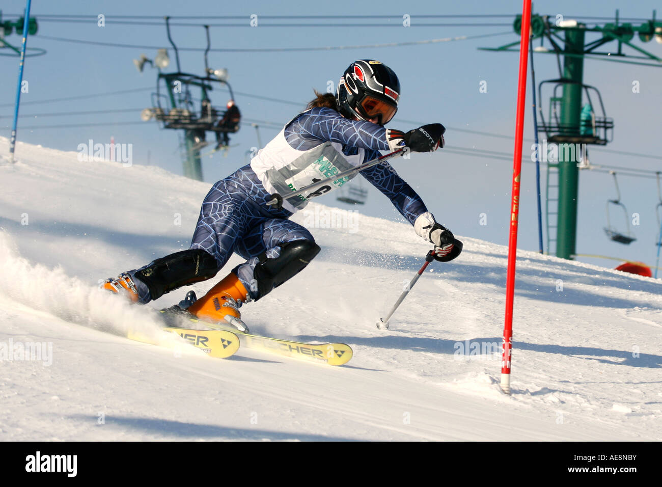 Girl approaching a gate in a ski race Stock Photo