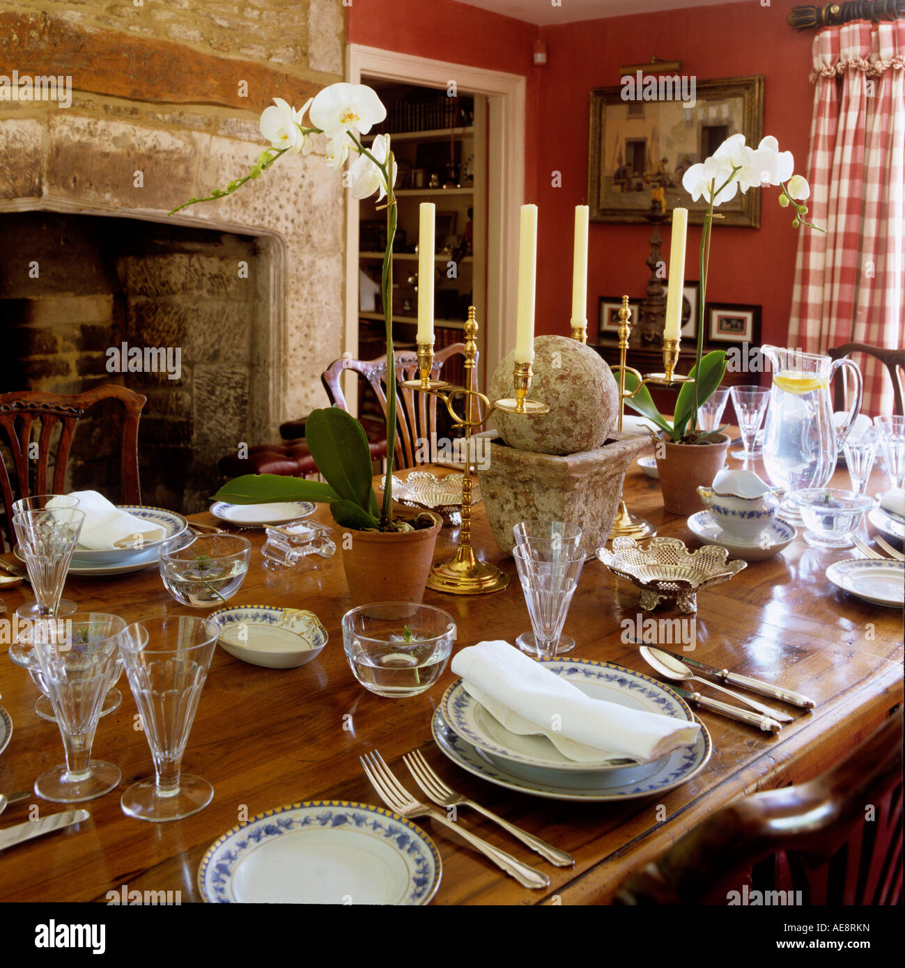 Close up of laid dining table and stone fire place in 17th century longhouse Stock Photo