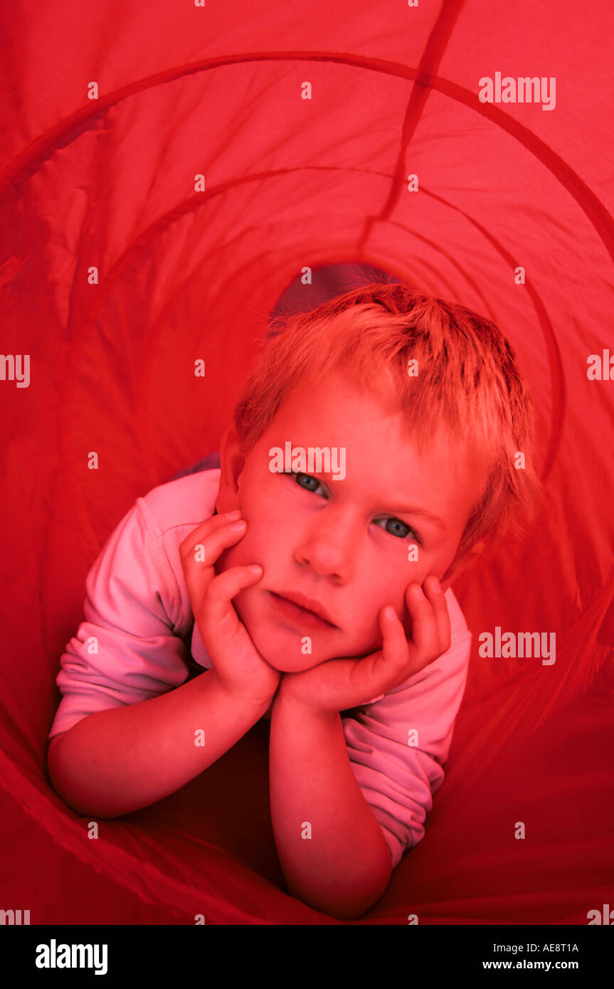 Young boy in play tunnel Stock Photo