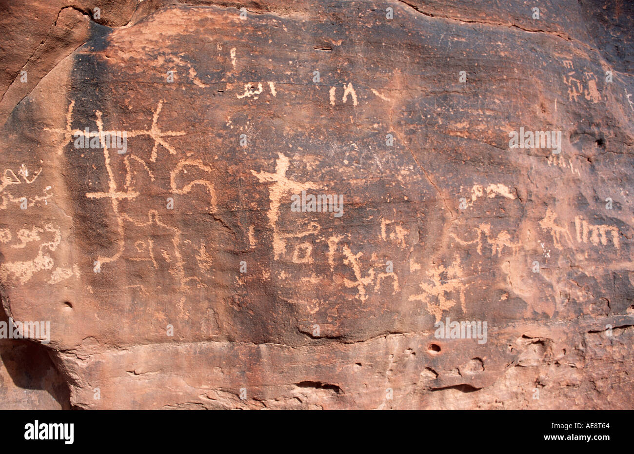 Ancient Nabataean petroglyphic inscriptions on sandstone rocks near Lawrence of Arabia s Spring Wadi Rum Jordan Middle East Stock Photo