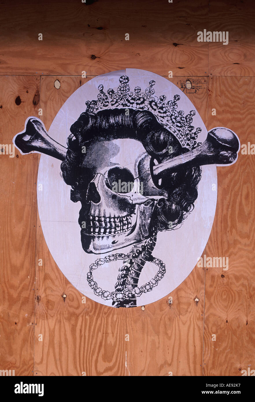 Wicked caricature of Queen Elizabeth II — depicting her as skeleton with tiara — on boarded up shop at Smithfield Market, London Stock Photo